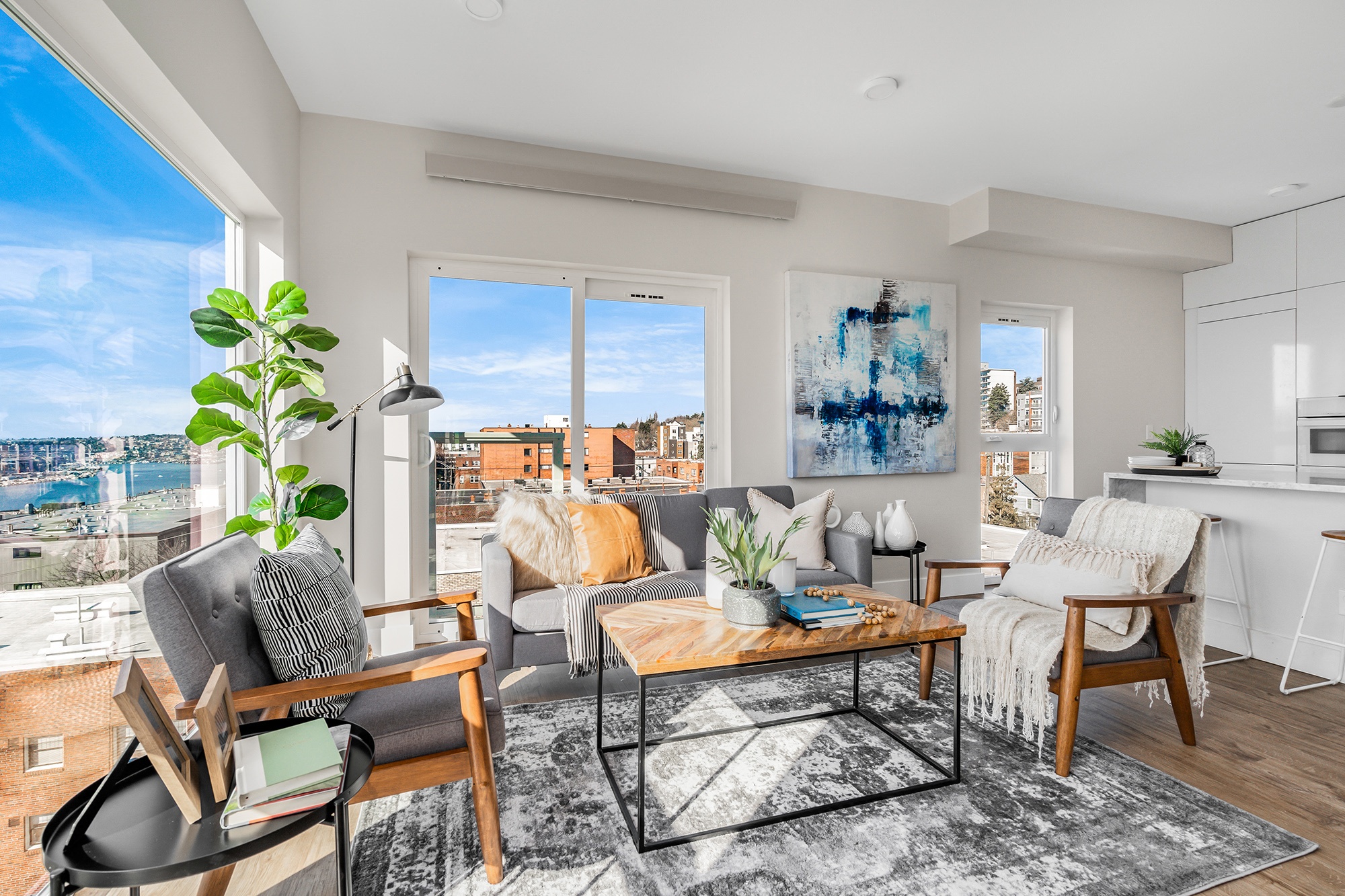 an open living room with a view of the city and a large window
